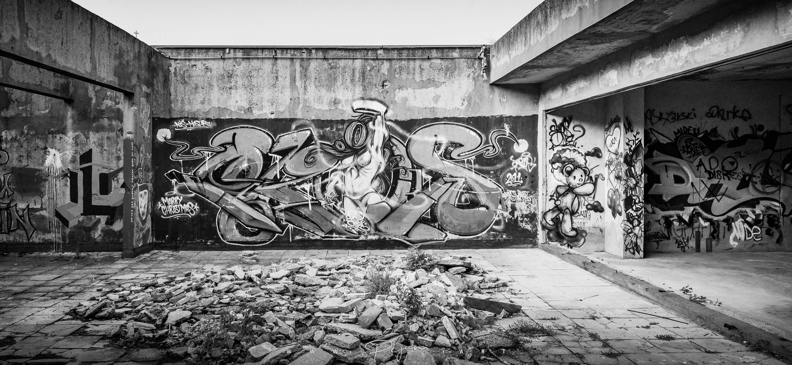 Urbex Black and White Photography, Street art on the top floor of the famous Sniper Tower in Mostar in Bosnia-Herzegovina. The building is a former bank left abandoned since the Bosnian war.