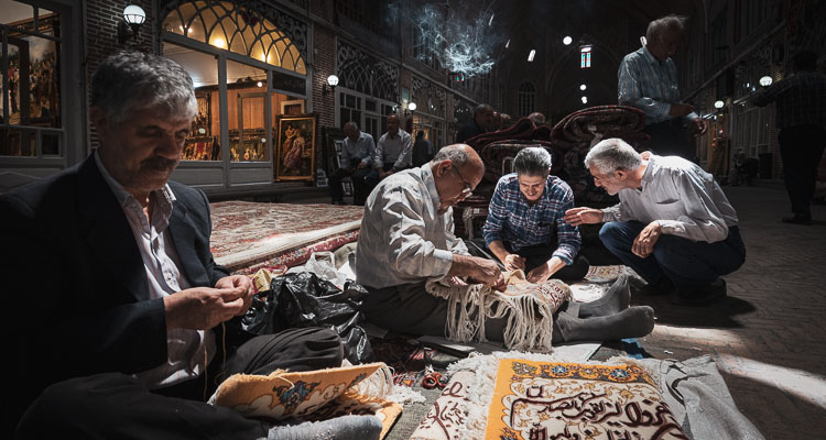 Grand Bazaar of Tabriz, artisans repairing traditional carpets, Western Azerbaijan, Iran